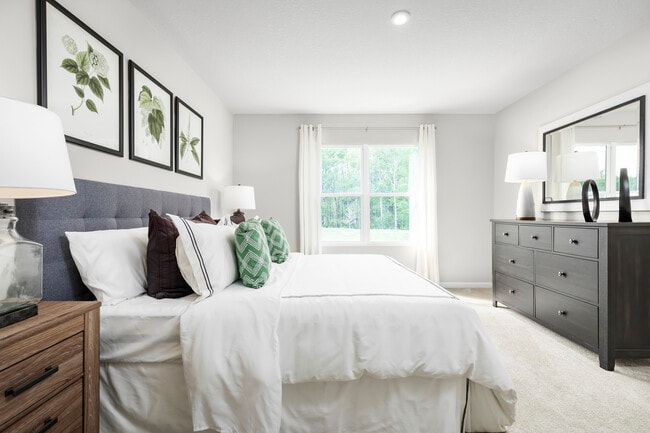 Experience the convenience of one-level living, with a spacious owner's suite with a double vanity and walk-in closet, plus a laundry area. Upstairs, you'll find two bedrooms and a full bathroom.