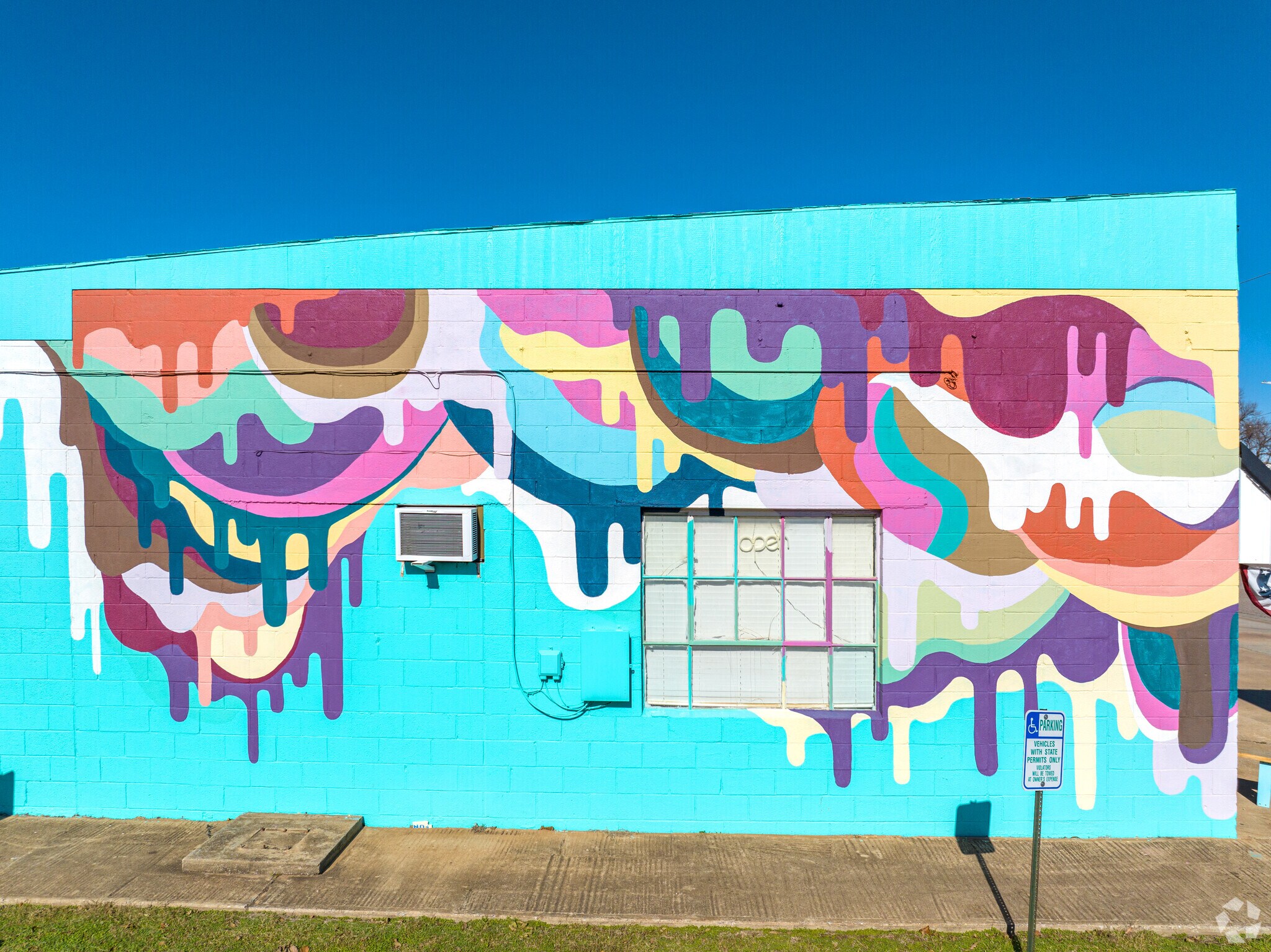 See the unique mural artwork on the side of Scoops Cookies and Cones.