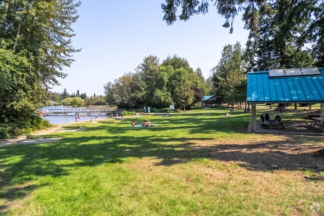 Lake Stickney locals lay out near the water and soak up the sun at Lake Stickney Park.