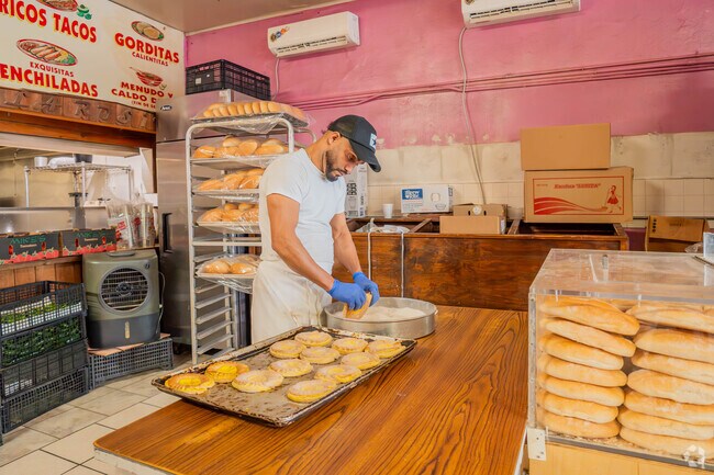 A baker prepares fresh treats for the morning rush at La Rosita in Galena Park.