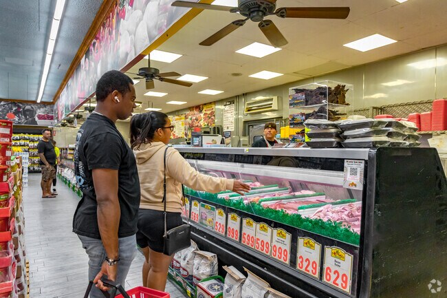 A couple browses the wide selection of meats at Kaelin's Market near Granite Hills.