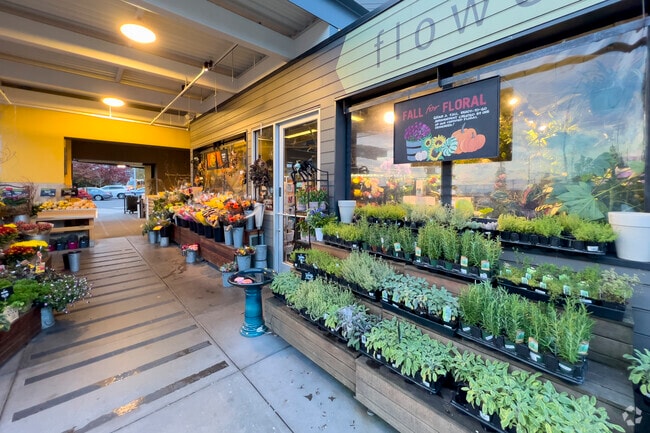 Metropolitan Market features vibrant floral displays alongside specialty foods.