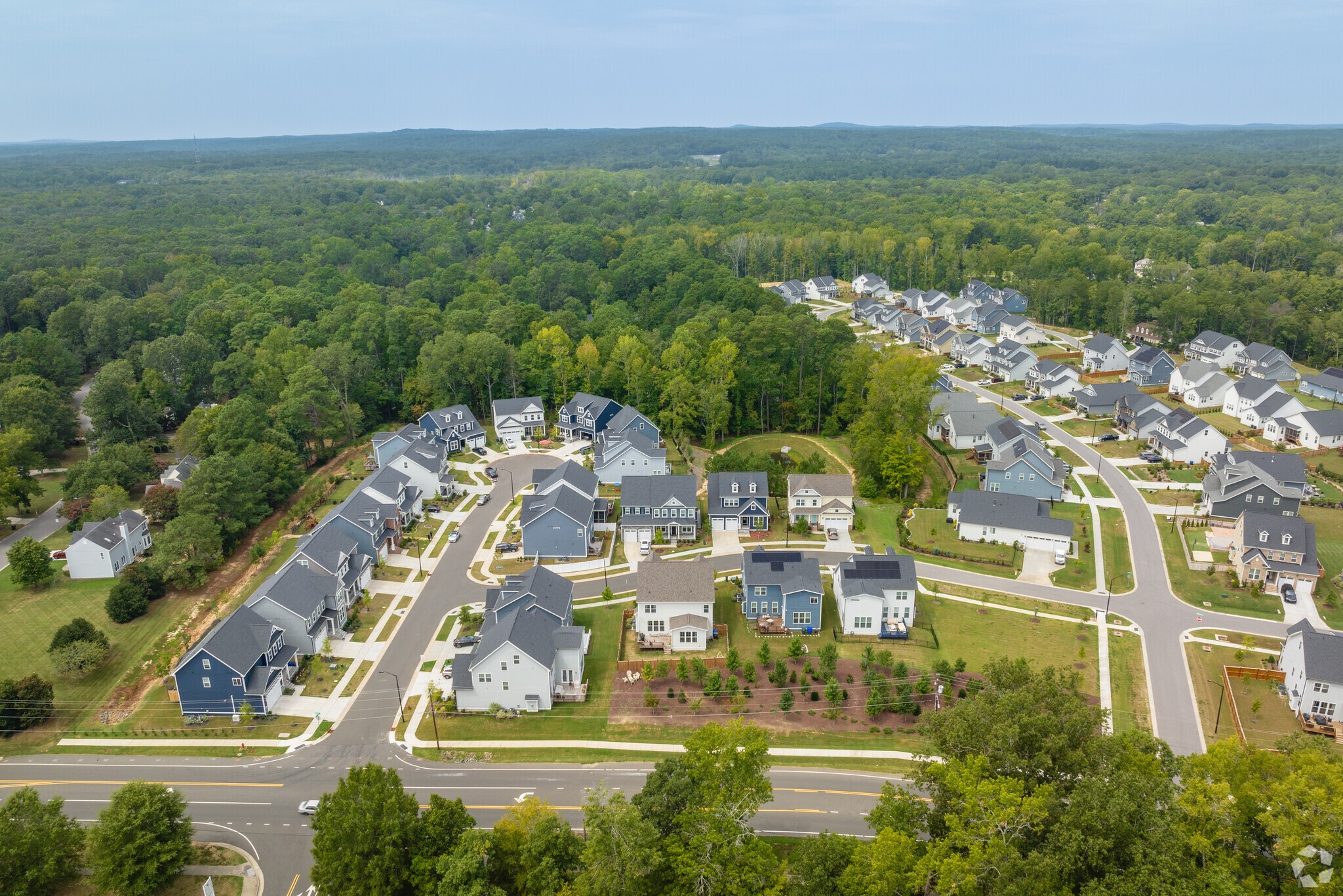 An aerial overview of a neighborhood with new 2-story homes.