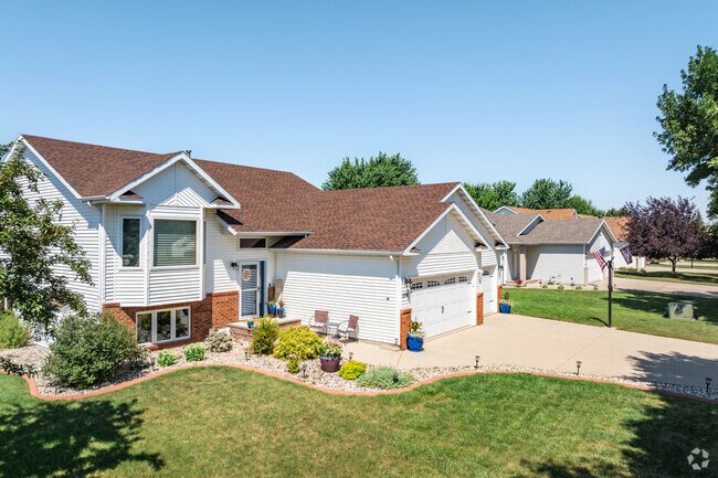 A row of two-story homes sits on a treelined street in Sommerset.