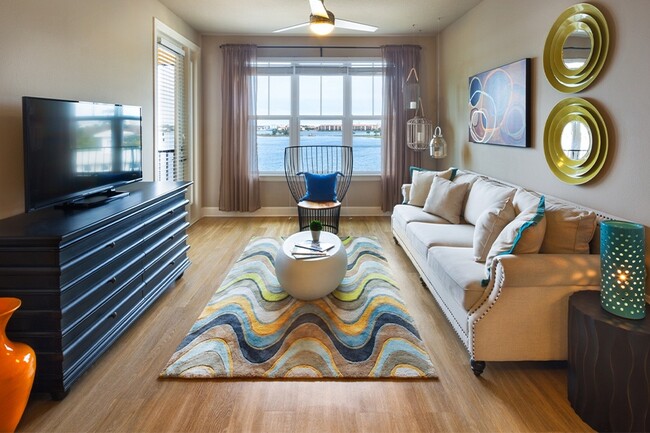 Inviting living rooms feature luxury vinyl plank flooring and ceiling fans
