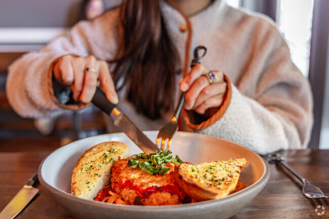 Diners can enjoy classics like Chicken Parmesan at Red Cork Bistro near Wind and Tide.