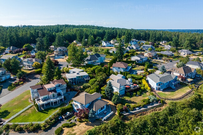 Homes sit atop a peninsula, offering stunning views of Puget Sound.