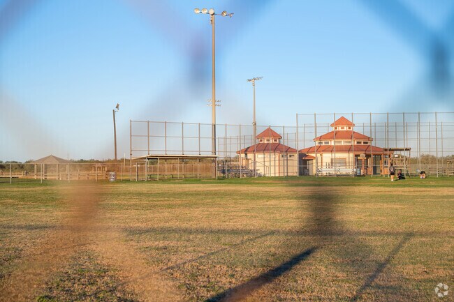 Guys enjoy baseball practice at the baseball field.