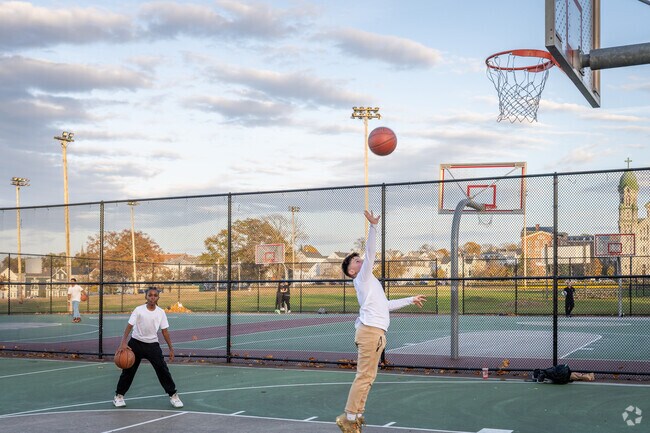 Young kids enjoy a day at the park playing basketball in Fall River near Somerset, MA.
