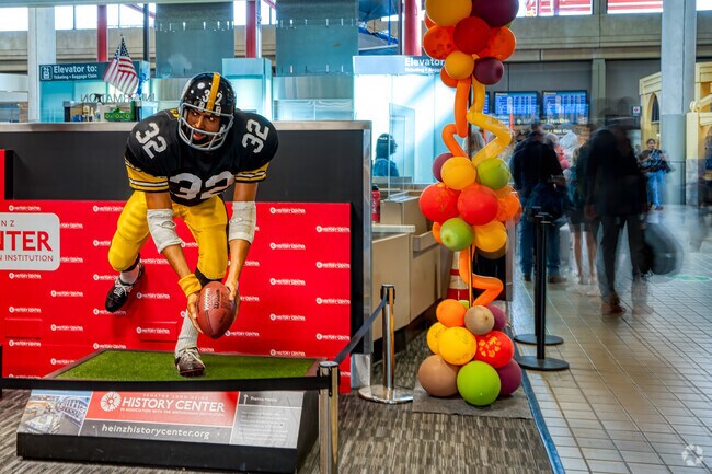 A statue in Pittsburgh International Airport memorializes Franco Harris' immaculate reception.