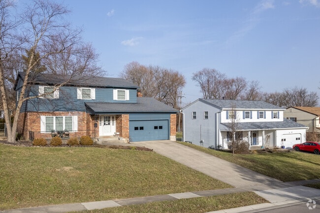 The exterior of a traditional home with siding showcases a blend of symmetrical design.