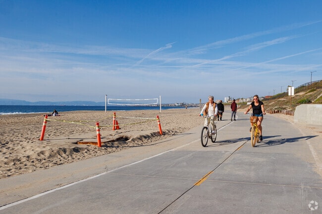 Riviera, CA residents ride their bikes along Torrance Beach.