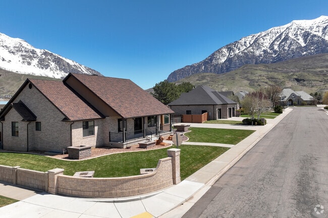 A tidy, modern brick home in the Orchard South neighborhood, set against a stunning mountain backdrop and framed by crisp lawns and clean, quiet streets.