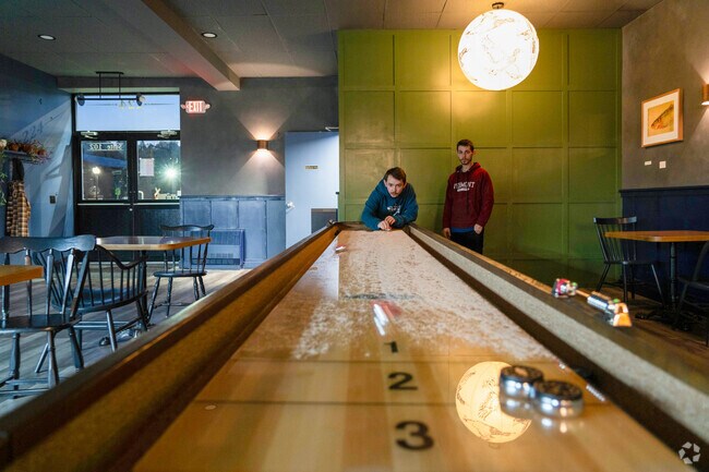 Folks play shuffleboard at Tally, a bar in Barre City, five minutes from South Barre.