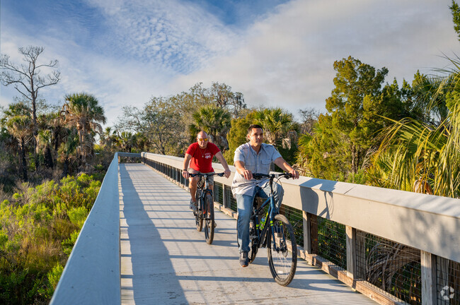 Cyclists ride along a boardwalk and natural trails at Werner-Boyce Salt Springs State Park near Millpond