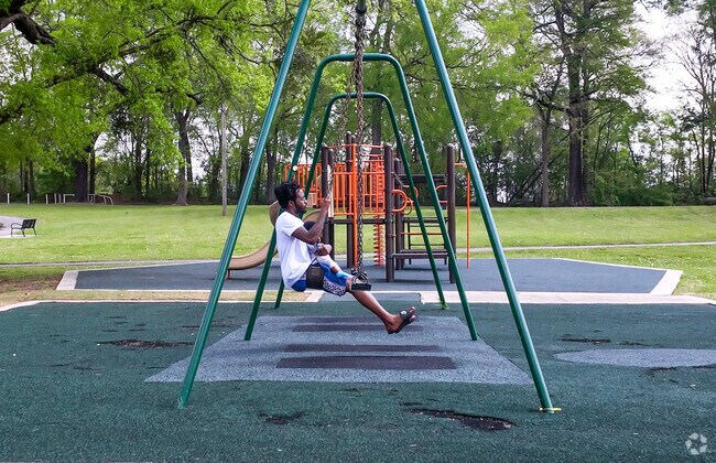 Man and his child swinging at North Birmingham Park