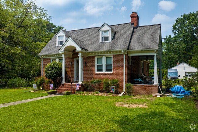 Cape Cods sit on maintained lawns with mature shade trees in the Pinkey Knolls neighborhood.