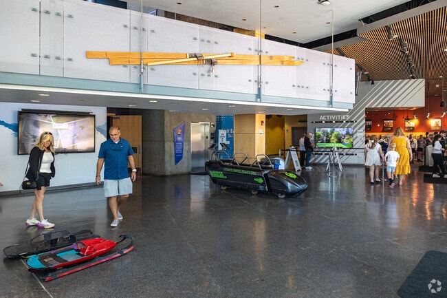 People enjoy the reception area of a museum at Utah Olympic Park.