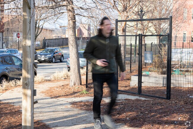 A Bowmanville residents walks past the community garden space.