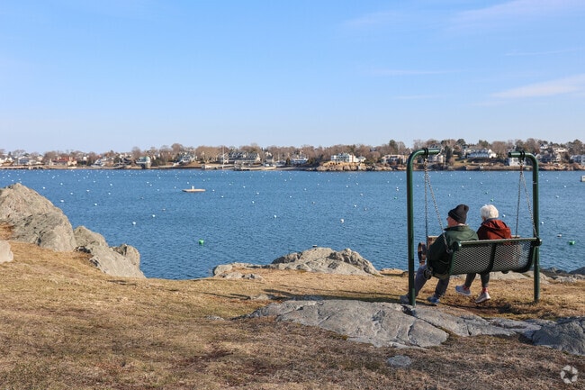 Couples of all ages in Marblehead enjoy the swings at Crocker Park.