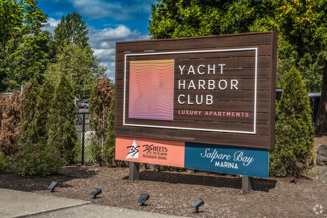 Signage at entrance to Yacht Harbor Apartments, Salpare Marina, and 3 Sheets Restaurant.