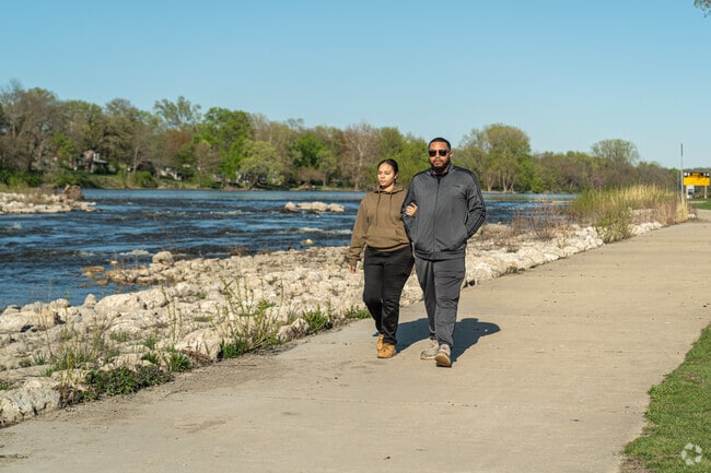 A couple walk along the Fox River at Yorkville's Bicentennial Riverfront Park.