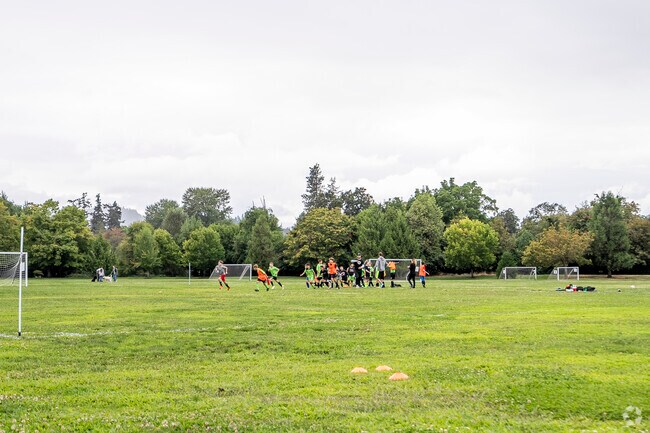 Young soccer players playing soccer at a field in Roseburg.