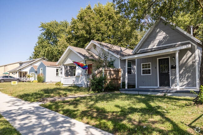 Newly renovated homes line a residential street in Robberson.