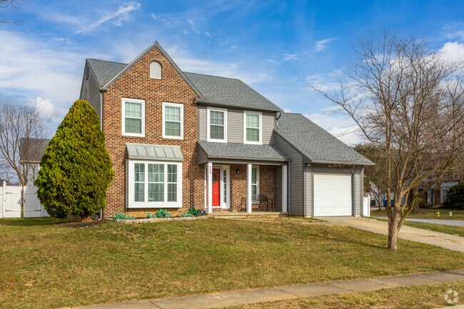 A Traditional single family home in a neighborhood with well-maintained sidewalks in Bear.