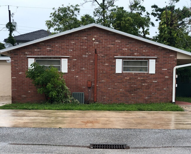 Exterior with two available parking spaces and an outdoor area for table/chairs and BBQ
