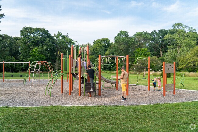 Families play on the playground at Island Park in Racine.