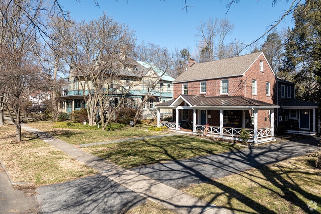 A brick colonial revival house sits next to a large Victorian on this quiet, Swarthmore street.