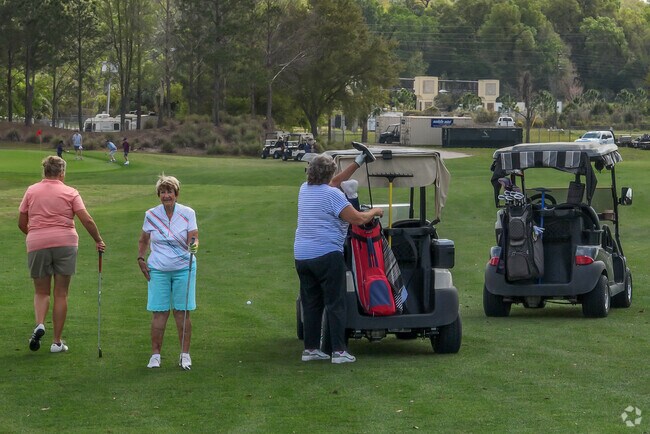 Golfers enjoying a round on the greens at Zellwood Station, a favorite gathering spot in the community.