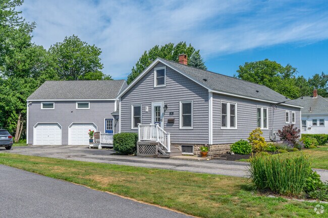 A pristine ranch style home with a barn and garage combo in the back.