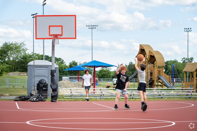 Enjoy shooting hoops with friends at the sports courts in Swansea Park.