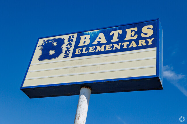A blue and white sign has the Braves’ mascot at Bates Elementary School.