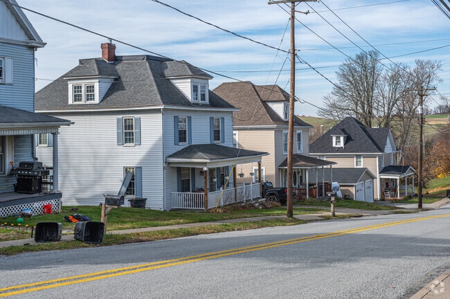 A row of Craftsman-style homes lines a busy road in Mount Pleasant Township.
