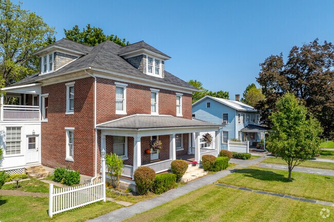 American foursquare homes in Boggs with white picket fences have 3 stories of living space.