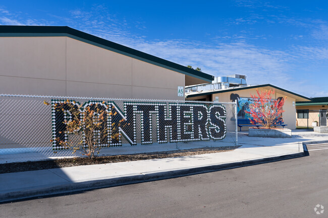A large sign shows the mascot of Palm Elementary School in Orosi.