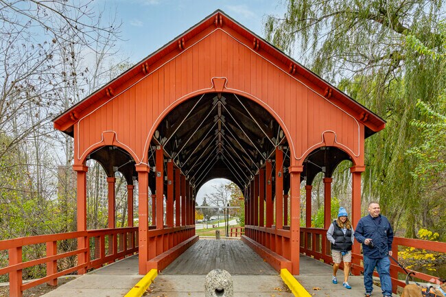A covered bridge separates the Ford Fields from the park's open event spaces.