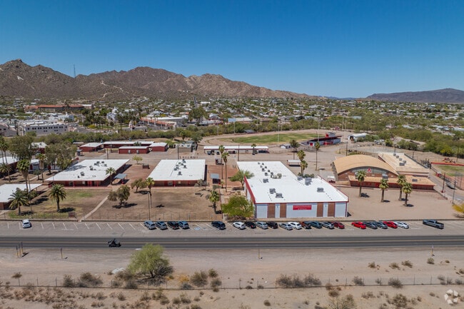 School buildings for both Ajo High and Ajo Elementary are set against a mountain backdrop, with facilities grouped closely together.