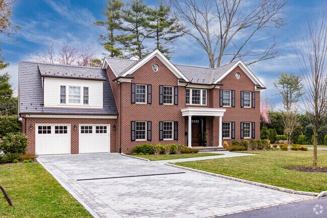 This immaculate brick clad colonial is a neighborhood knockout in Munsey Park.