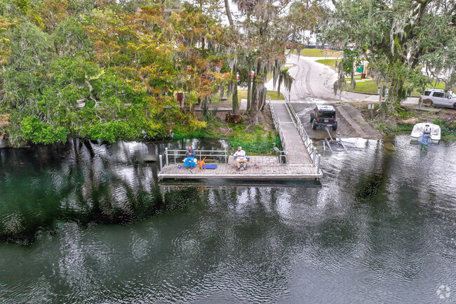 A riverside view 2 men fishing on N. Florida's Avenue Boat Ramp in Dunnellon, Fl.
