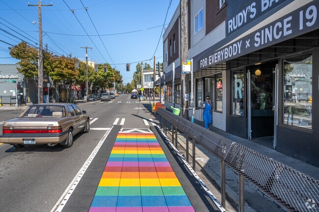 A Pride rainbow decorated bus stop on Capitol Hill, right on 15th Avenue East.