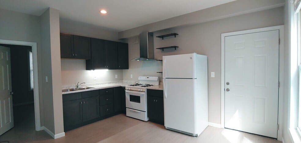 Open concept kitchen with new wood cabinets.