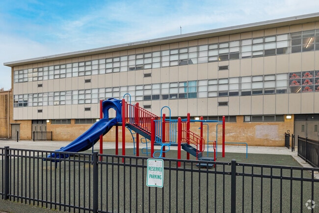 Charles A Mooney School outdoor playground beckons with colorful equipment.