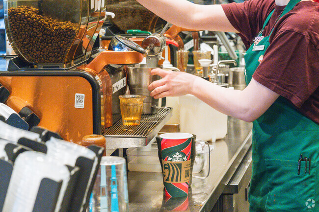 A barista makes a coffee drink at the Starbuck in Downtown East Lansing.