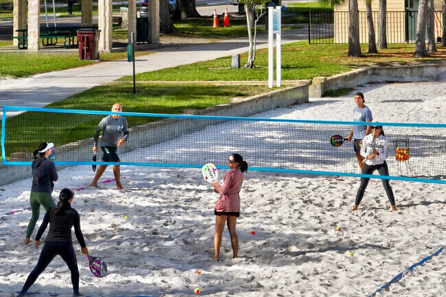 A group of friends playing a pick up game of pickleball on Lakeshore Park.