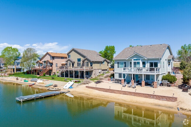 Contemporary style homes on the shores of Hidden Lake in Berkley have small boating docks.