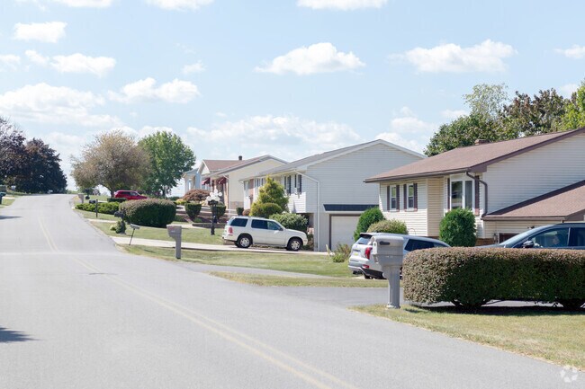 Along streets in the Greenwood neighborhood, a gentle slope delineates the row of homes.